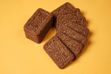 Square-shaped chocolate biscuits are suitable as a side snack to the breakfast menu. Start the morning with biscuits. Can be consumed by all ages from toddlers to the elderly. Stack of biscuits.