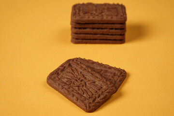 Square-shaped chocolate biscuits are suitable as a side snack to the breakfast menu. Start the morning with biscuits. Can be consumed by all ages from toddlers to the elderly. Stack of biscuits.