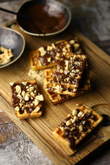 Selective focus. French waffles with chocolate and nuts. Delicious dessert.