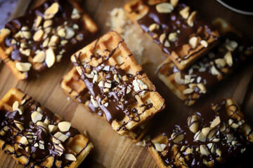 Selective focus. French waffles with chocolate and nuts. Delicious dessert.