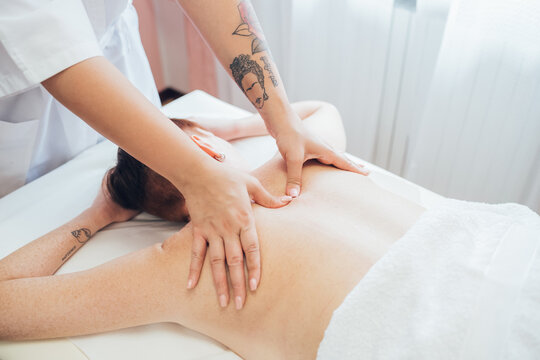 Woman getting a back massage in a beauty salon.