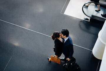 Couple in business suits kissing