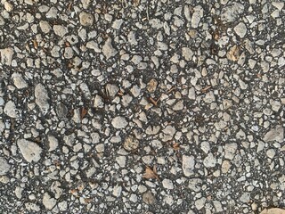 Gray small granite stone floor. Dry asphalt texture and pre gravel stone background