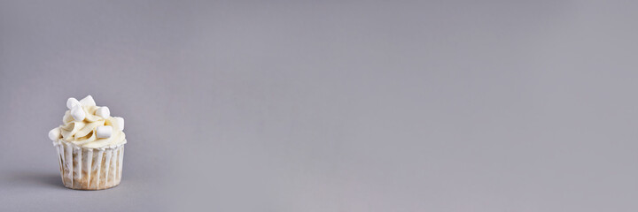 Milky cream cupcake. Birthday sweet bakery. Cookies. Yummy buttercream dessert. Wedding party food. Grey background. Holiday recipe. Anniversary gourmet. One pieces. Marshmallow