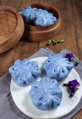 Bakpao bunga telang, bakpau or baozi, Chinese steamed bun is tint with blue butterfly pea