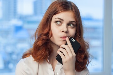 Business woman talking on the phone in the office to professionals