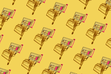 Many same shop trolley on yellow bright background. Modern mall concept. Top view repeat layout. Market cart trend wallpaper. Flatlay. Supermarket empty accessory