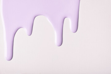 Lilac liquid drops of paint color flow down, isolated white background. Abstract purple backdrop with fluid drip pattern