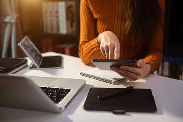  Woman using smart phone for mobile payments online shopping,omni channel,sitting on table,virtual...