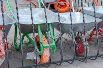 Fototapeta premium New garden wheelbarrows on one wheel for sale.