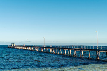 Fototapeta na wymiar Marion Bay jetty with fishermen on a day, Yorke Peninsula, South Australia