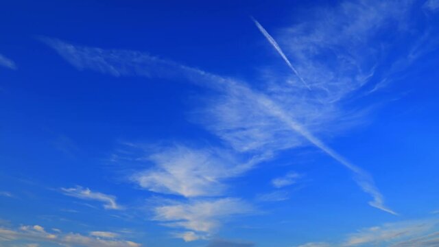White cirrus clouds floating in blue sky