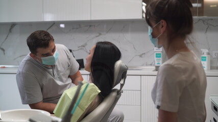 Dentistry. Dental care. Young attractive woman at the doctor appointment. Clinic.