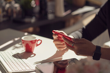 Close up of a hand man holding a smartphone at work.