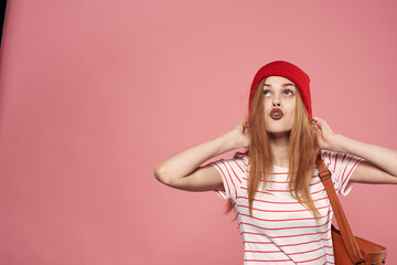 Naklejka premium Emotional woman fashion clothes studio fun pink background