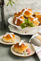 Easter buns and colorful eggs on a table