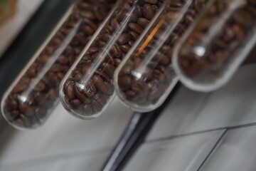 Coffee bean in the glass tube Selective focus.