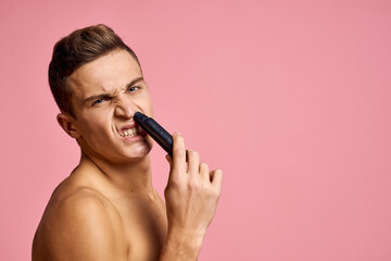 Cute man naked shoulders skin care hygiene pink background