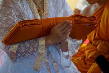 Newly ordained Buddhist monk pray with priest procession