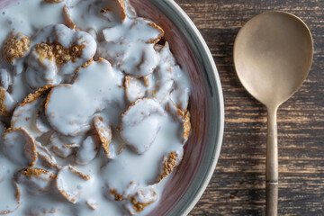Whole grain glazed flakes with yogurt in plate. Healthy breakfast, whole grain muesli in a bowl