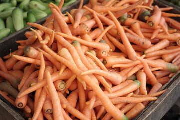 a collection of red carrots at a traditional market. fresh vegetables ready to be sold for consumption. foods full of nutrients and vitamin A for eye health