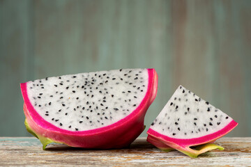 Dragon fruits isolated on an old wood background.