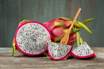 Dragon fruits isolated on an old wood background.