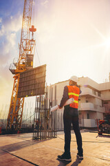 Smart civil architect engineer inspecting and working outdoors structure building site with...