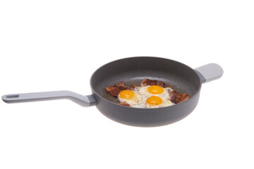 fried scrambled eggs with bacon in a frying pan