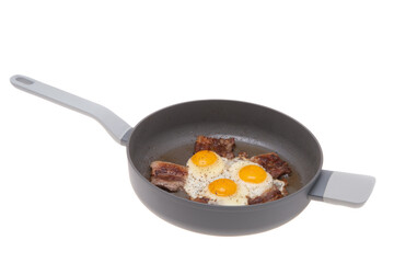 fried scrambled eggs with bacon in a frying pan