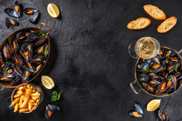 Mussels with wine, lemon, and French fries, overhead flat lay shot