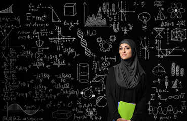 Female Arab student near blackboard