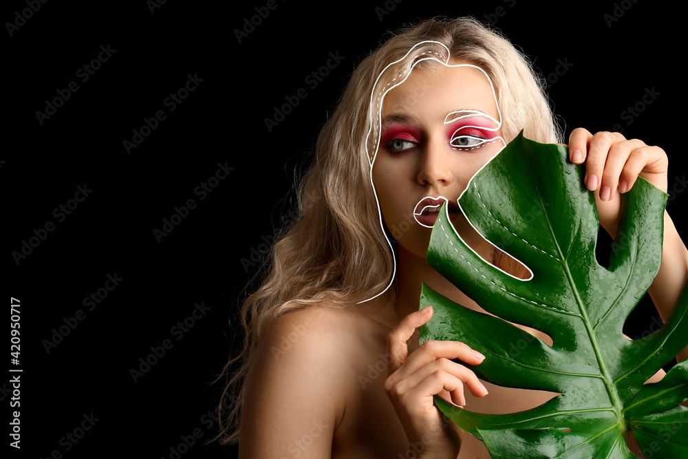 Canvas Prints Beautiful young woman with tropical leaf on dark background