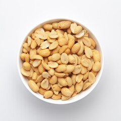 Close up of crunchy roasted Peanuts Indian namkeen (snacks) on a ceramic white bowl. Top view