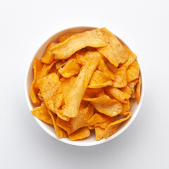 Close up of Soya Chips crunchy and salty Indian Namkeen on a ceramic white bowl. Top view