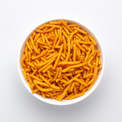 Close up of Nimbu masala besan sev Indian namkeen (snacks) on a ceramic white bowl. Top view
