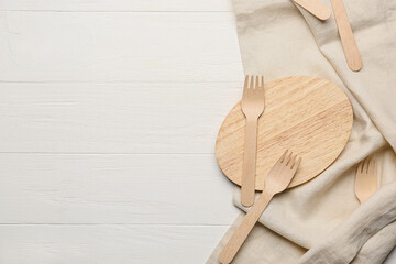 Wooden forks on light background