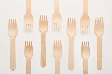 Wooden forks on light background