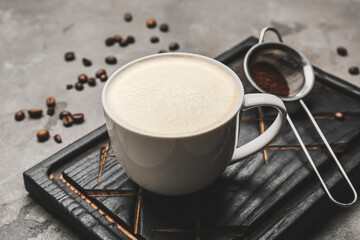 Cup of tasty latte on grunge background