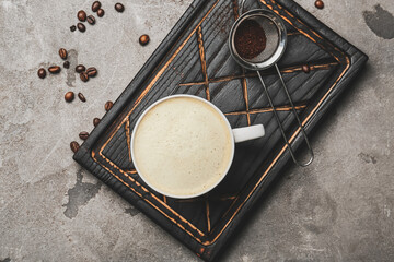 Cup of tasty latte on grunge background