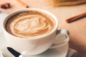 Cup of tasty latte on color background, closeup