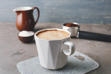 Cup of tasty latte on grunge background