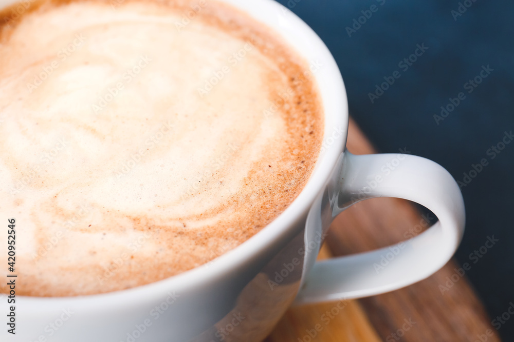 Wall mural cup of tasty latte on dark background