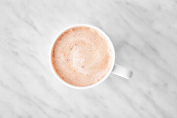 Cup of tasty latte on light background