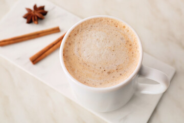 Cup of tasty latte on light background