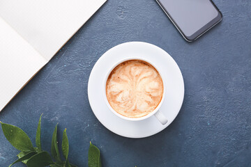 Cup of tasty latte on dark background