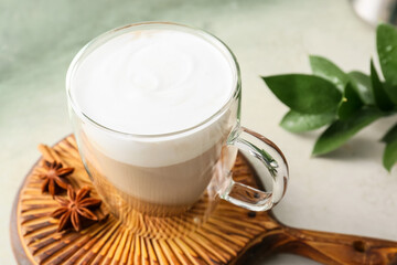 Glass cup of tasty latte on light background