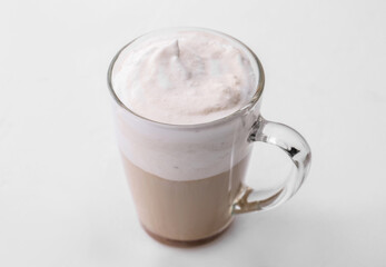 Glass cup of tasty latte on light background