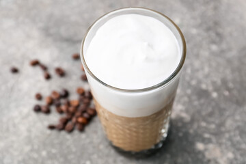 Glass of tasty latte on grey background