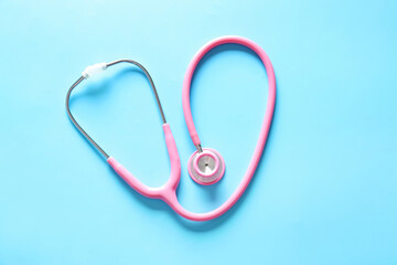 Modern stethoscope on color background